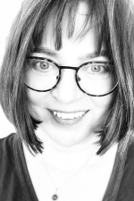 Headshot of Anja Wanner in black and white. She has a chin-length bob with bangs and tortoiseshell glasses.