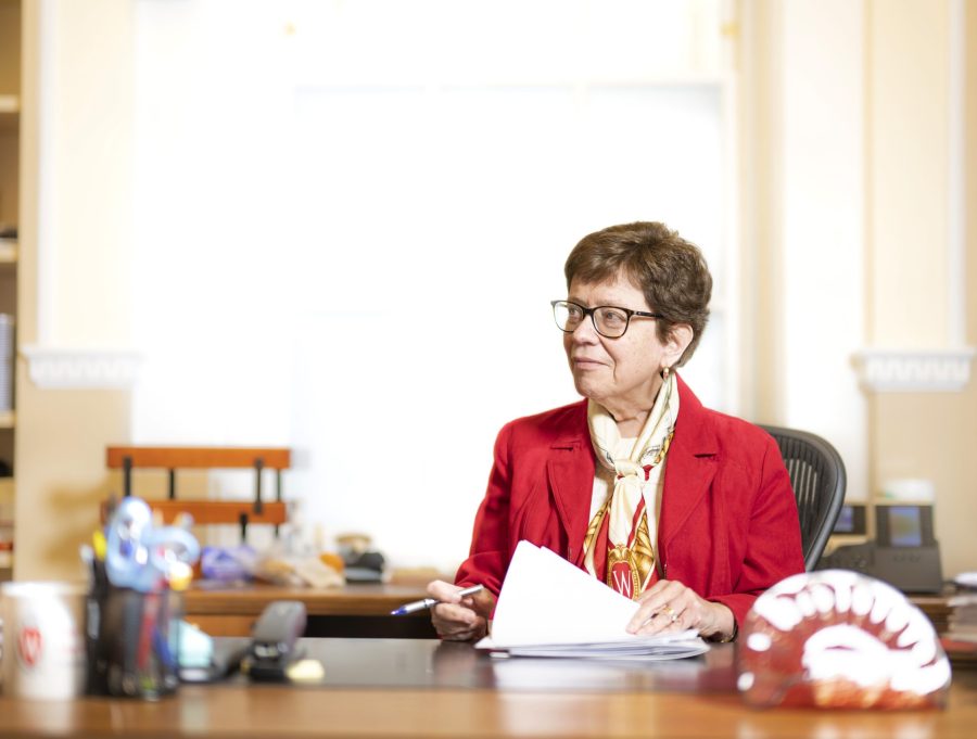 Rebecca Blank is pictured seated at her desk in the chancellor's office. She is looking to the side at something out of frame.